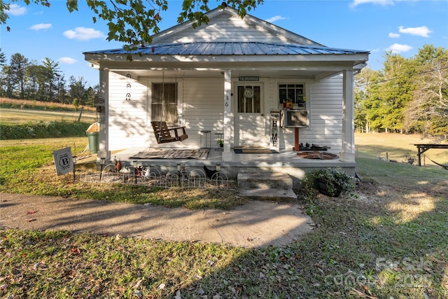 rear view of property featuring a porch