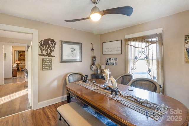 dining space with hardwood / wood-style flooring and ceiling fan