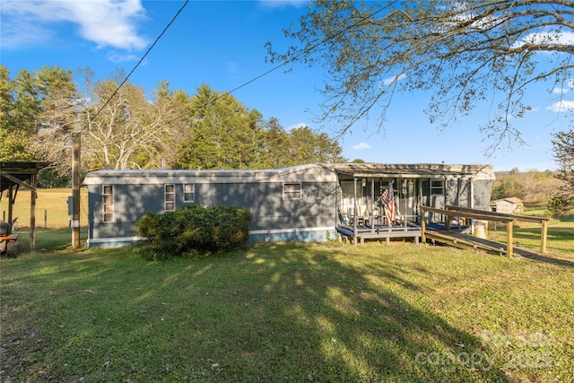 back of property featuring a yard and a deck