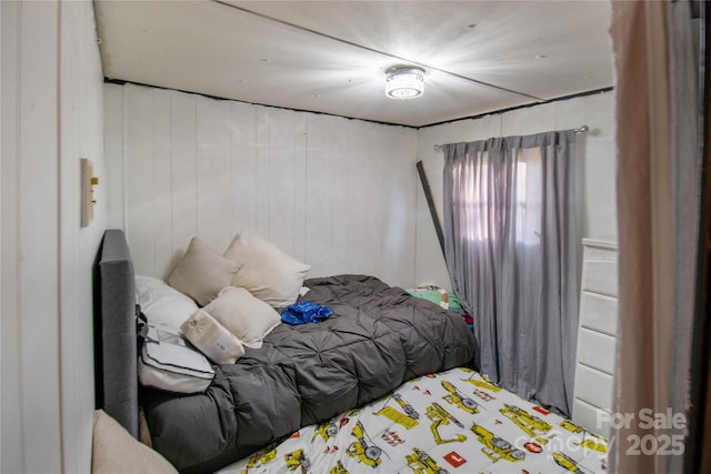 bedroom with wooden walls