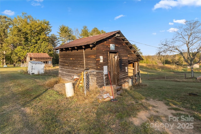 view of outbuilding with a yard