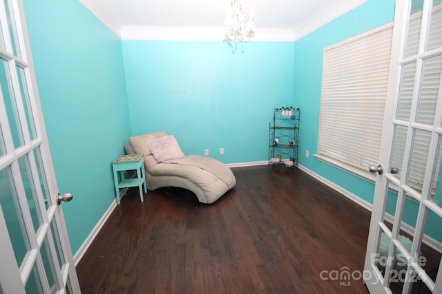 unfurnished room with ornamental molding, hardwood / wood-style floors, a notable chandelier, and french doors