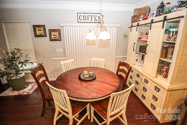 dining area featuring ornamental molding, dark wood-type flooring, a barn door, and a notable chandelier