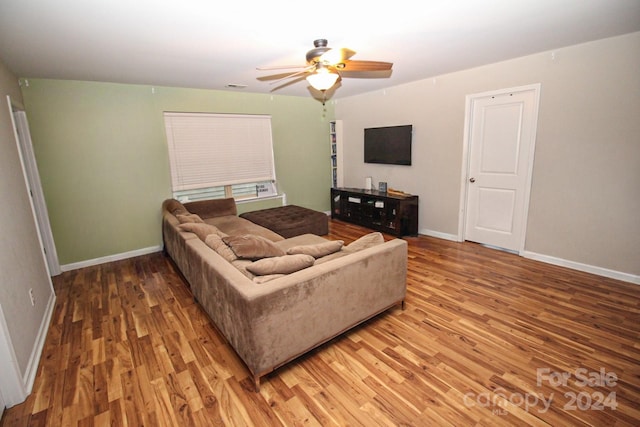 living room with wood-type flooring and ceiling fan