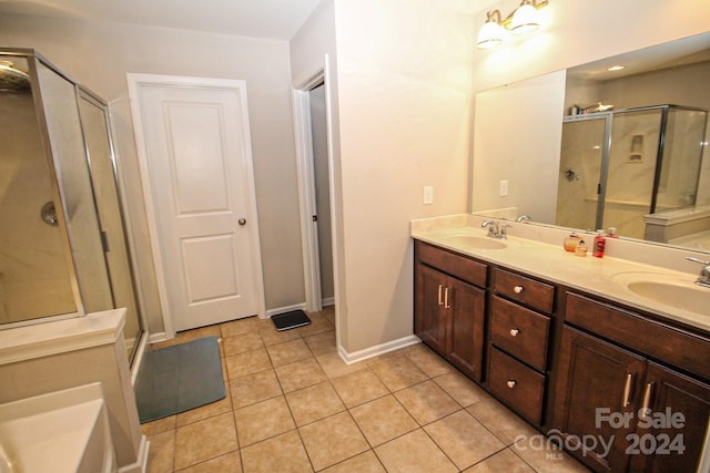 bathroom featuring vanity, tile patterned flooring, and walk in shower