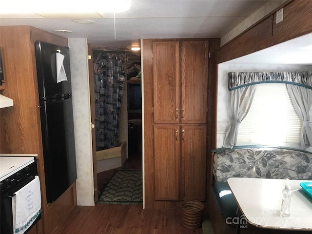 interior space featuring hardwood / wood-style flooring and a shower with curtain