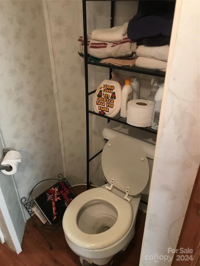 bathroom featuring hardwood / wood-style floors and toilet