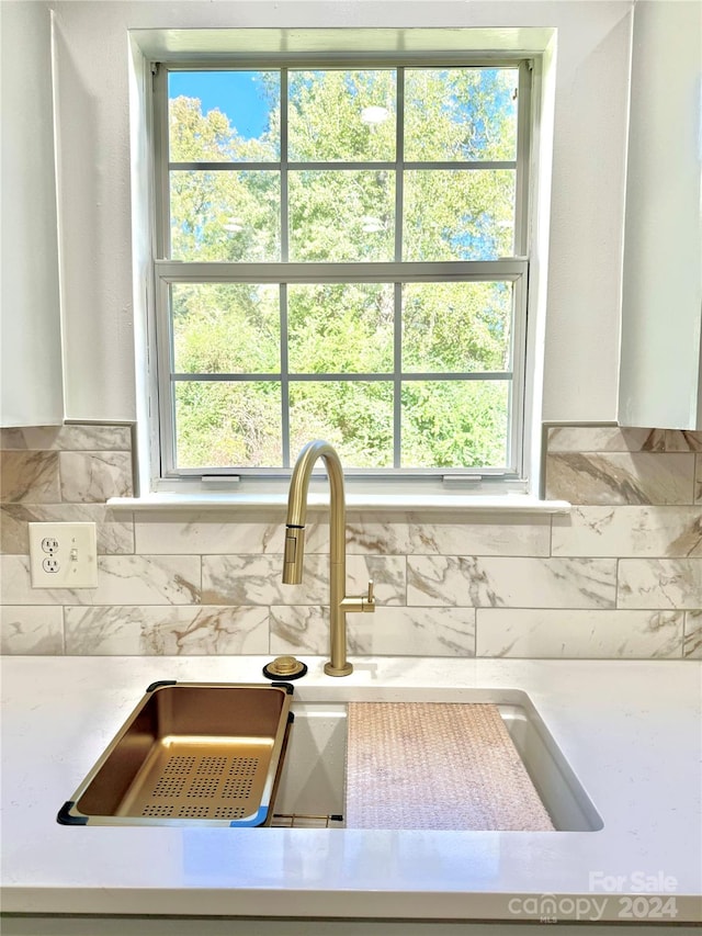 room details featuring sink and decorative backsplash