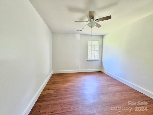 empty room featuring wood-type flooring and ceiling fan