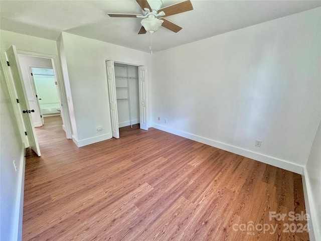 unfurnished bedroom featuring ceiling fan, a closet, and light hardwood / wood-style floors