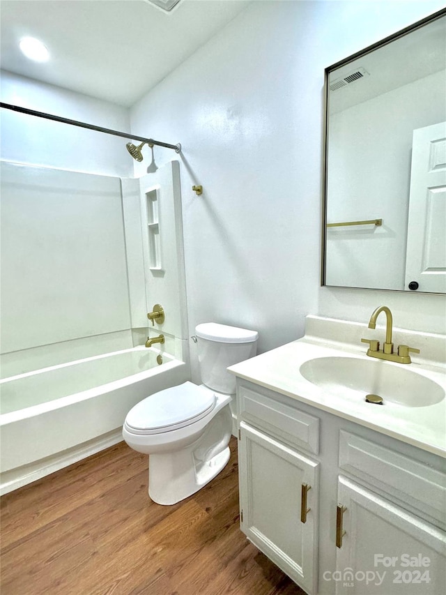 full bathroom featuring tub / shower combination, vanity, toilet, and wood-type flooring