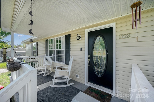 doorway to property with a porch