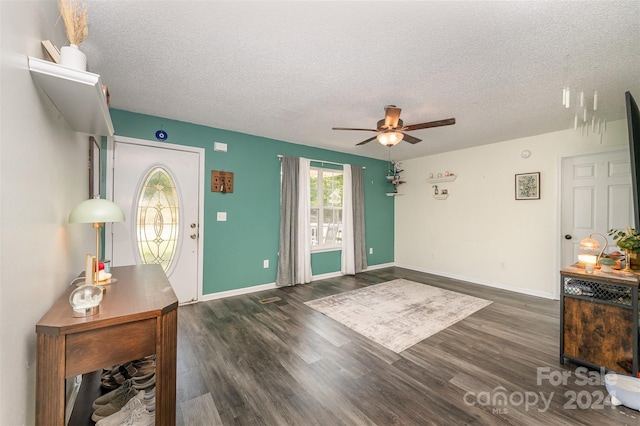 entryway featuring a textured ceiling, ceiling fan, and wood finished floors