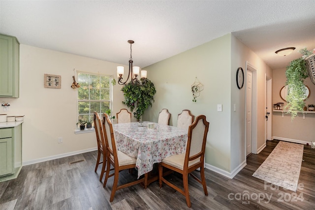 dining area featuring baseboards, visible vents, dark wood finished floors, and a chandelier