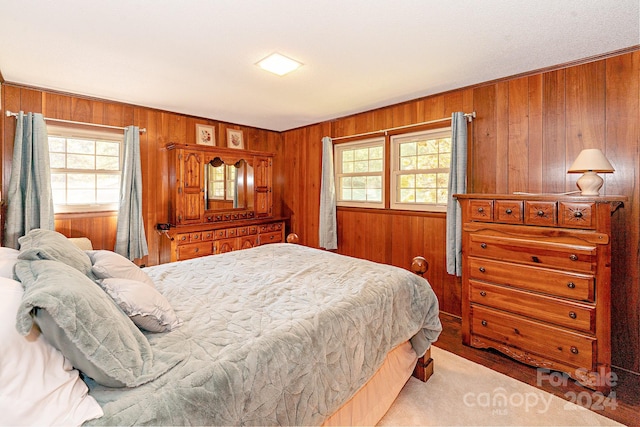 bedroom featuring wood walls