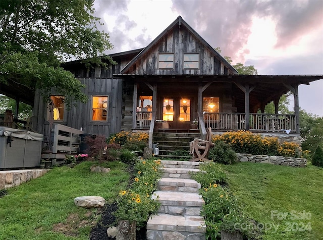 view of front of house featuring a yard and covered porch