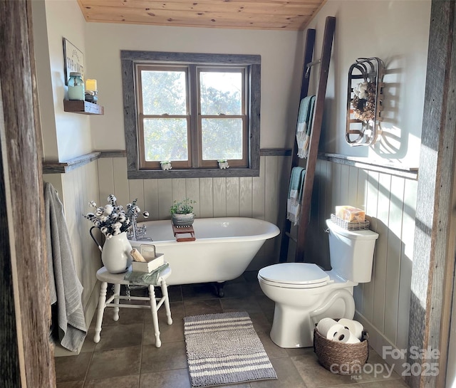 bathroom featuring wood ceiling, toilet, a bathing tub, and tile patterned flooring