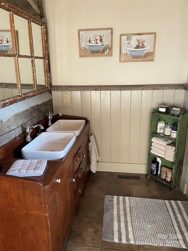 bathroom with tile patterned floors and vanity