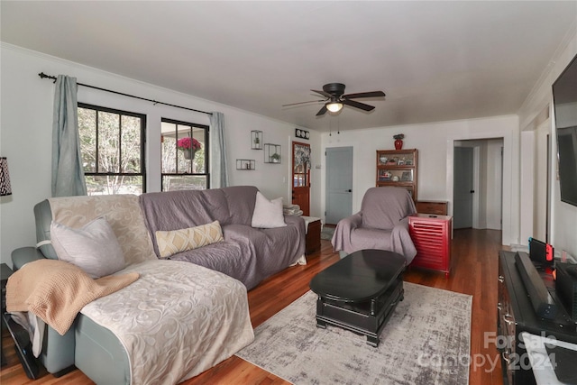 living room with ceiling fan, crown molding, and dark hardwood / wood-style floors