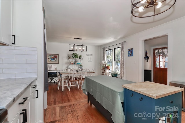 interior space with a center island, white cabinetry, hardwood / wood-style flooring, and blue cabinets