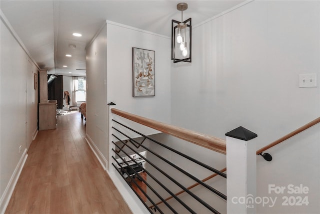 hall with ornamental molding and hardwood / wood-style flooring