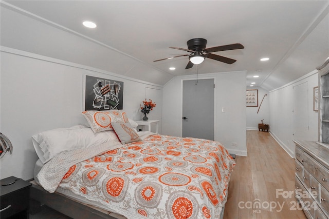 bedroom with vaulted ceiling, light wood-type flooring, and ceiling fan