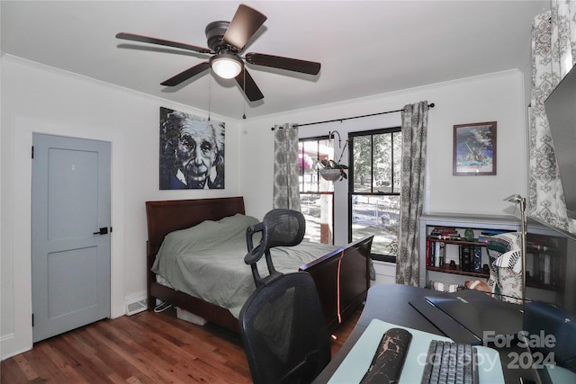 bedroom with ornamental molding, dark wood-type flooring, and ceiling fan