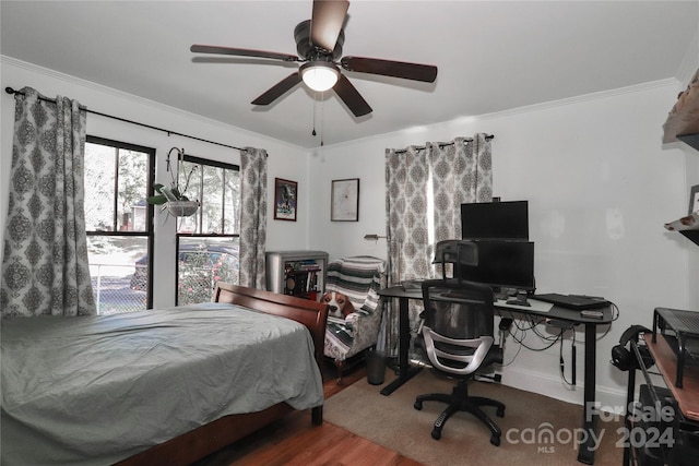 bedroom featuring crown molding, hardwood / wood-style flooring, and ceiling fan