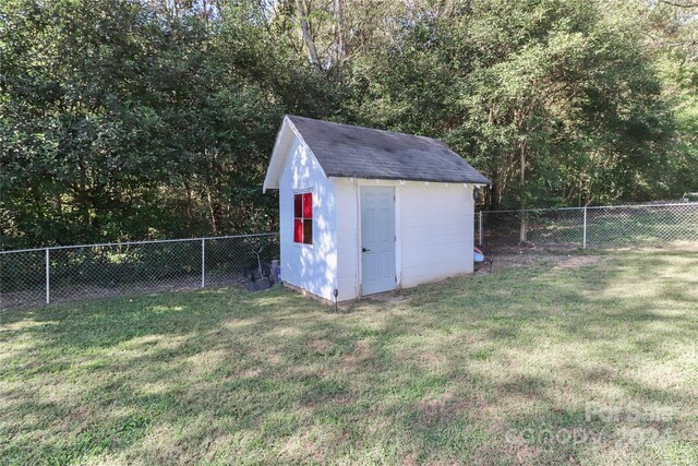 view of outbuilding featuring a lawn