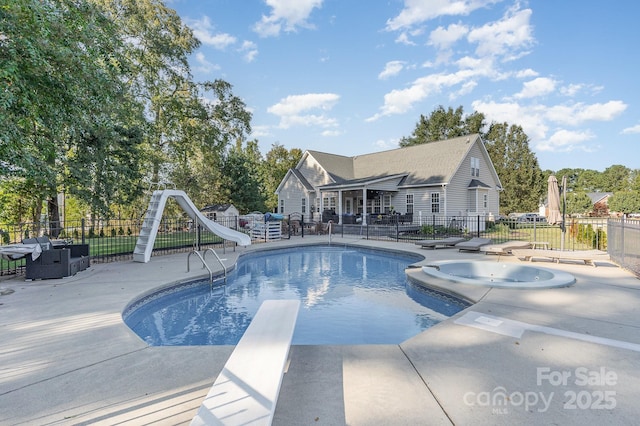 9404 Perimeter Ct, Zebulon, NC 27597 - view of swimming pool featuring a water slide, a patio, a diving board, a pool with connected hot tub, and grilling area