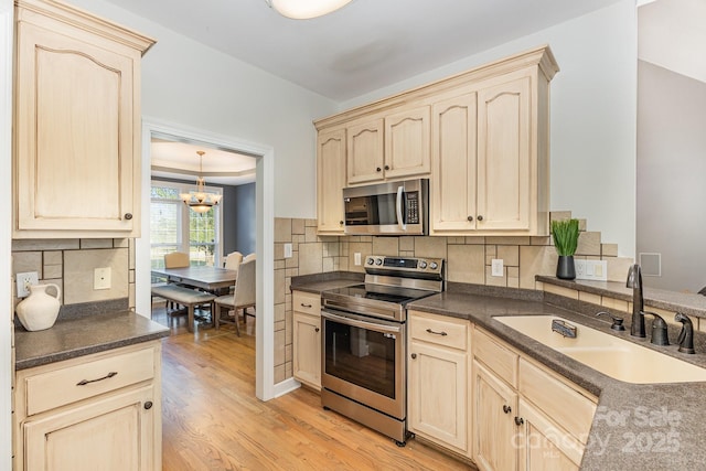 9404 Perimeter Ct, Zebulon, NC 27597 - kitchen with appliances with stainless steel finishes, light brown cabinetry, decorative backsplash, and dark countertops