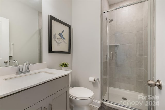 bathroom featuring an enclosed shower, vanity, toilet, and tile patterned flooring