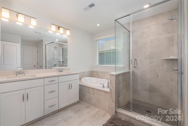 bathroom featuring shower with separate bathtub and vanity