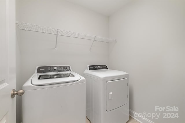 laundry room featuring washing machine and clothes dryer