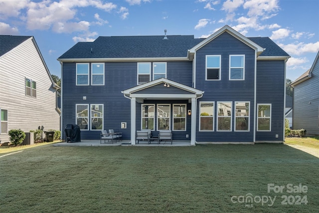 rear view of house featuring a yard, central AC, and a patio area