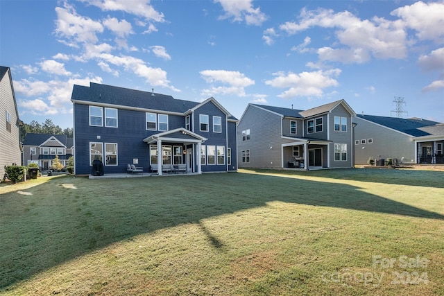 back of property with central AC, a yard, and a patio