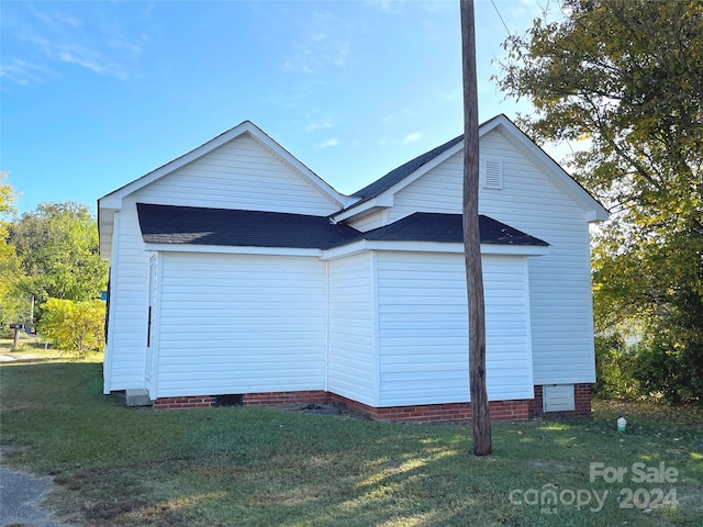 view of side of home with a lawn