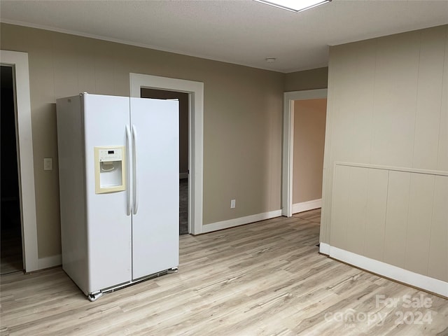 kitchen featuring white refrigerator with ice dispenser, a textured ceiling, and light hardwood / wood-style floors