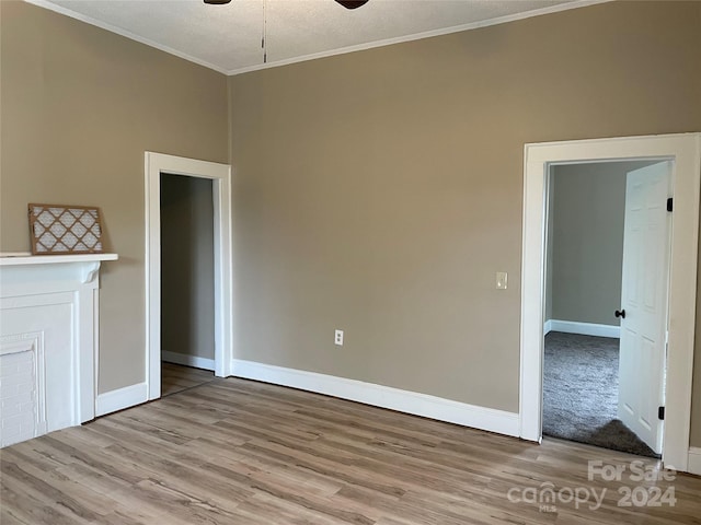 unfurnished room featuring a textured ceiling, crown molding, ceiling fan, and light hardwood / wood-style flooring