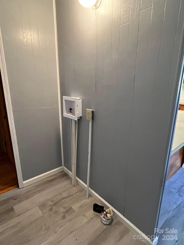 clothes washing area with washer hookup and wood-type flooring