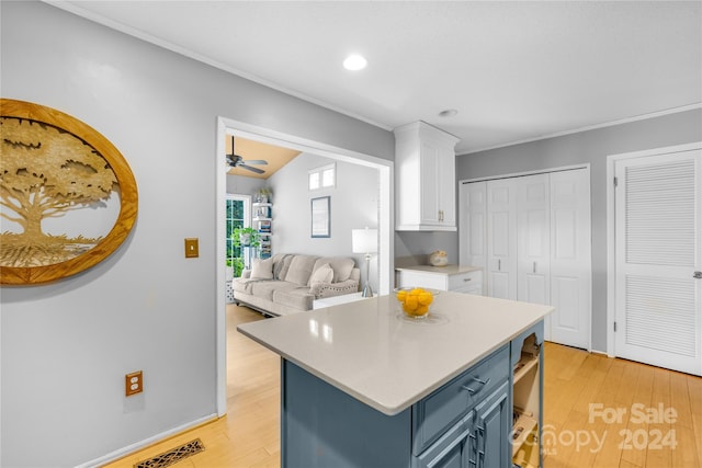 kitchen with light hardwood / wood-style floors, white cabinetry, ceiling fan, and blue cabinetry