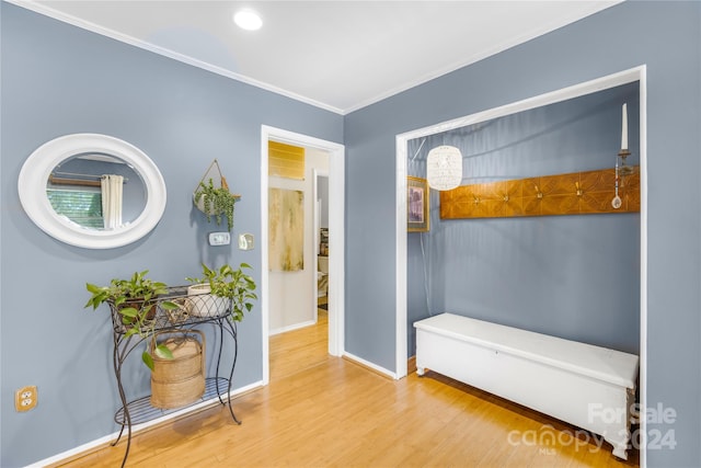 interior space with ornamental molding and light hardwood / wood-style flooring