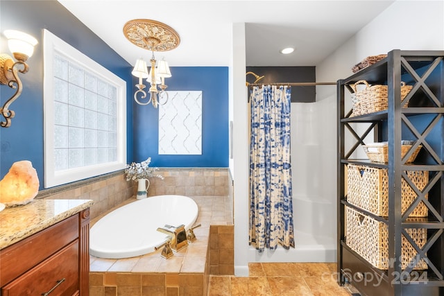 bathroom featuring vanity, shower with separate bathtub, and tile patterned floors