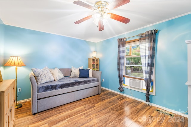 interior space with ornamental molding, hardwood / wood-style floors, cooling unit, and ceiling fan