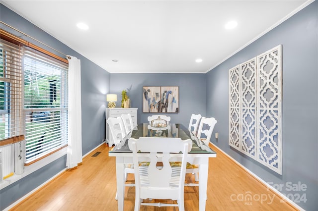 dining room featuring wood-type flooring and ornamental molding