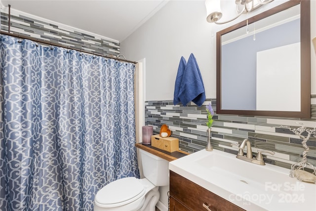 bathroom with vanity, toilet, curtained shower, and backsplash