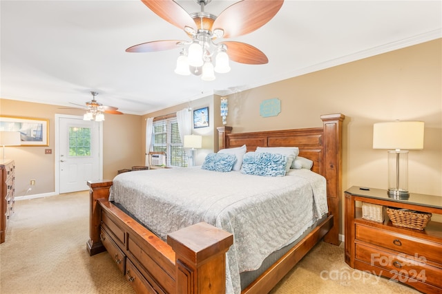 bedroom with crown molding, light colored carpet, and ceiling fan