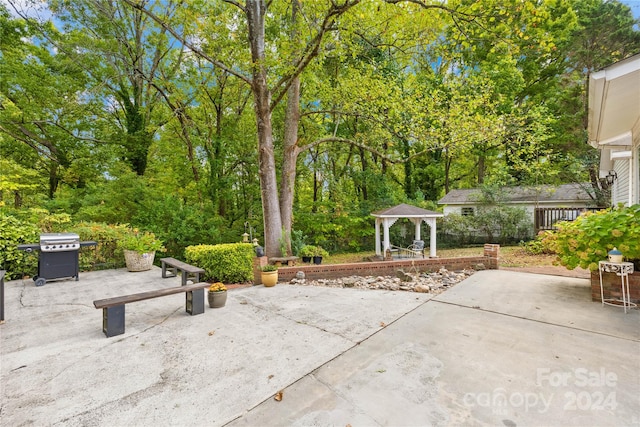 view of patio featuring a gazebo and a grill