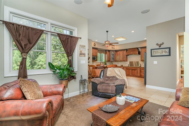 living room featuring light tile patterned floors and ceiling fan