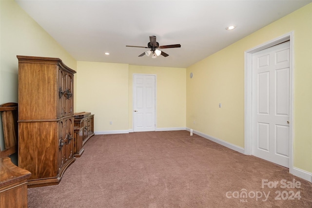 interior space featuring ceiling fan and carpet